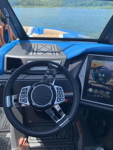 Slide: The Image of 2021 Tigé ZX Class 25 ZX boat dashboard with steering wheel and touchscreen display. - 11