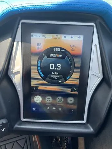 Slide: The Image of 2021 Tigé ZX Class 25 ZX touchscreen dashboard display showing speed and RPM. - 13
