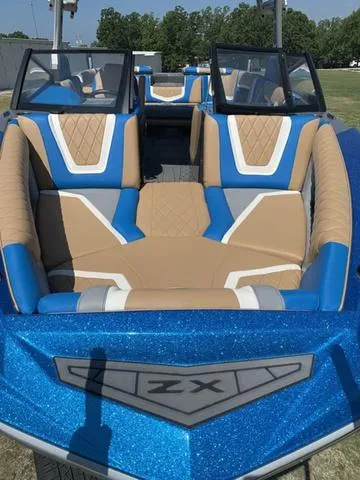 Slide: The Image of 2021 Tigé ZX Class 25 ZX boat with blue and tan interior. - 14