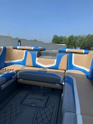 Slide: The Image of 2021 Tigé ZX Class 25 ZX boat interior with blue and tan seating. - 16
