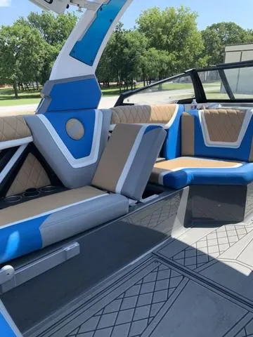 Slide: The Image of 2021 Tigé ZX Class 25 ZX boat interior with blue and beige seating. - 18