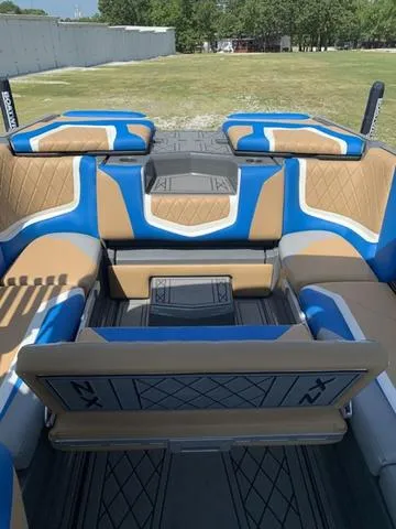 Slide: The Image of 2021 Tigé ZX Class 25 ZX boat interior with tan and blue seating. - 19