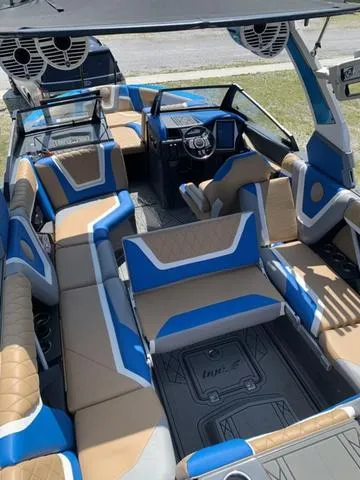 Slide: The Image of 2021 Tigé ZX Class 25 ZX boat interior with blue and tan seating. - 20