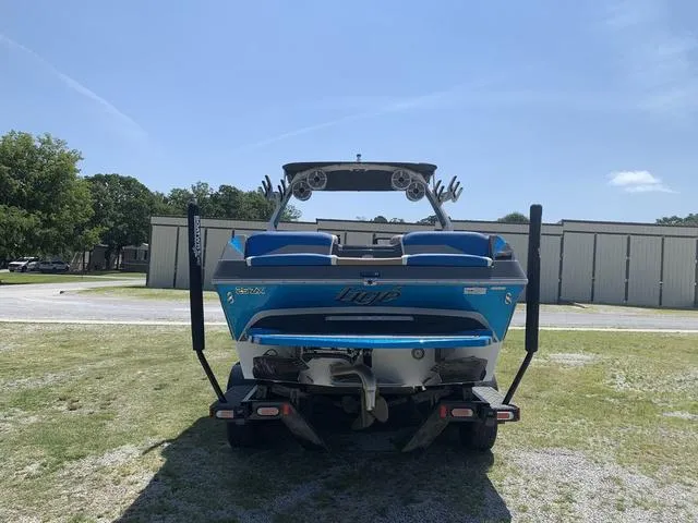 Slide: The Image of 2021 Tigé ZX Class 25 ZX boat, rear view, blue and white, on a trailer. - 4