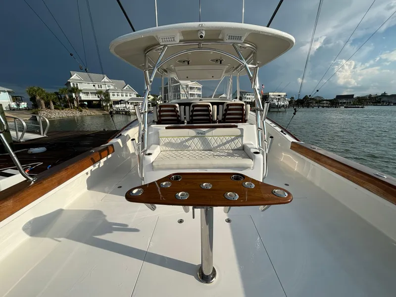 Slide: The Image of 2025 Mystique Boatworks M48 Custom Carolina, sleek design, spacious deck, luxury seating, waterfront view. - 12