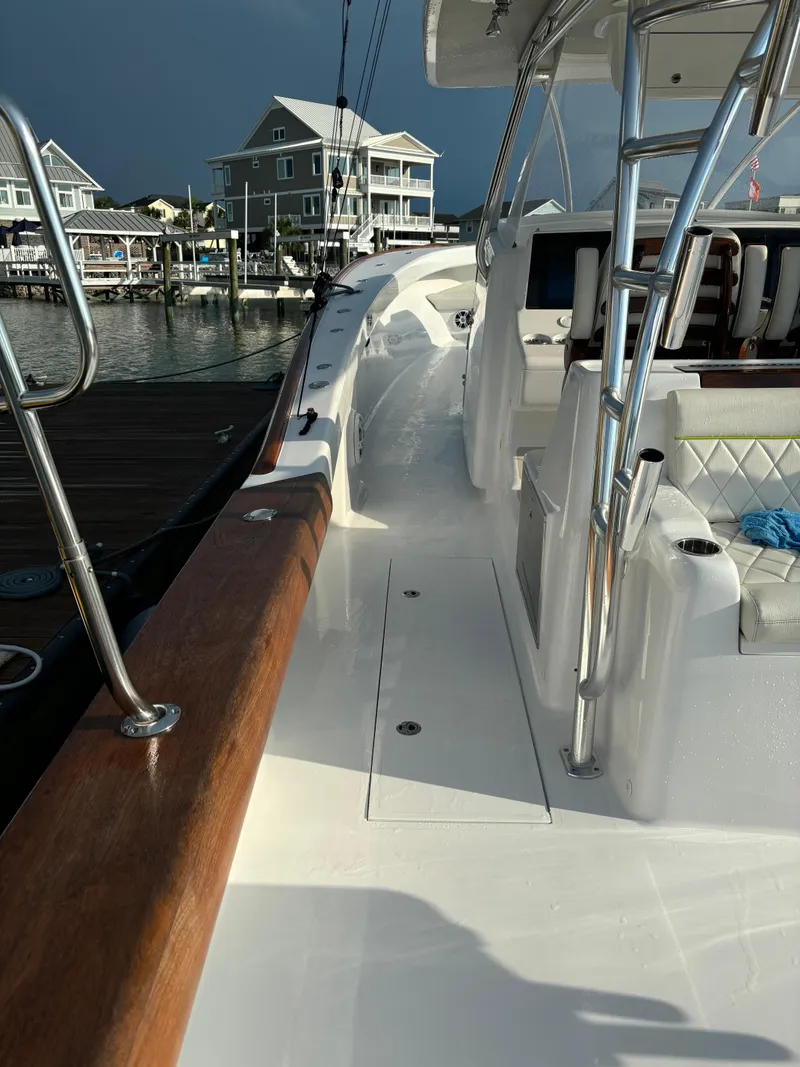 Slide: The Image of 2025 Mystique Boatworks M48 Custom Carolina docked, showcasing sleek design and modern features. - 14