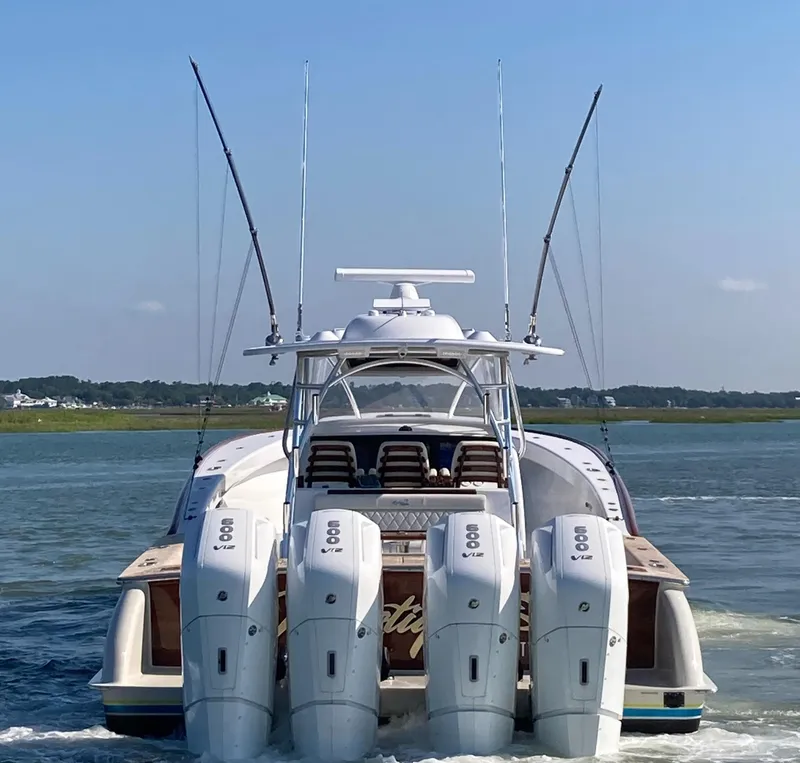 Slide: The Image of 2025 Mystique Boatworks M48 Custom Carolina with quad engines on the water. - 2