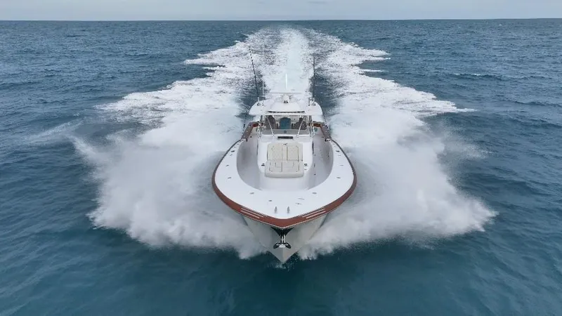 Slide: The Image of 2025 Mystique Boatworks M48 Custom Carolina speeding on open ocean waters. - 4