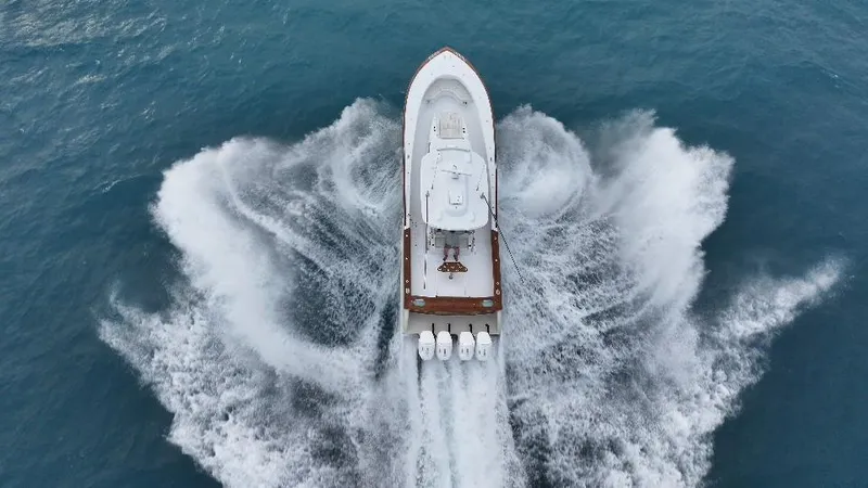 Slide: The Image of Aerial view of 2025 Mystique Boatworks M48 Custom Carolina speeding on ocean. - 5