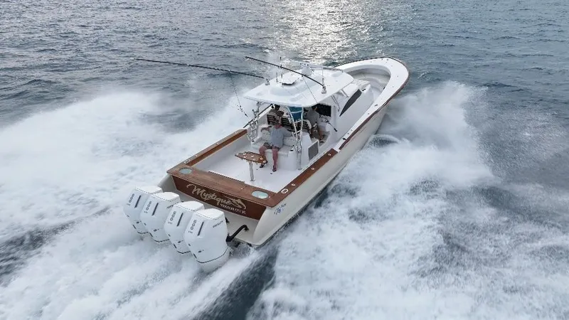 Slide: The Image of 2025 Mystique Boatworks M48 Custom Carolina cruising on open water. - 6