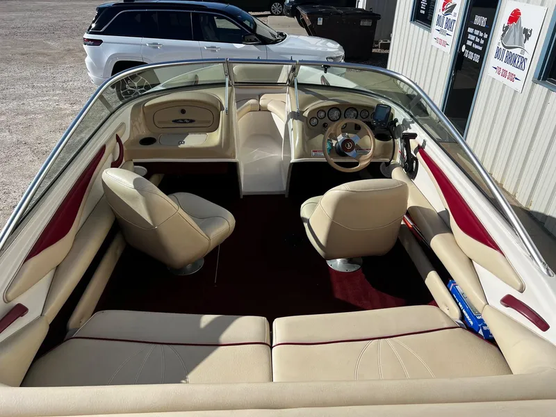 Slide: The Image of Interior of a 2000 Sea Ray 185 Bow Rider boat with beige and red seating. - 4
