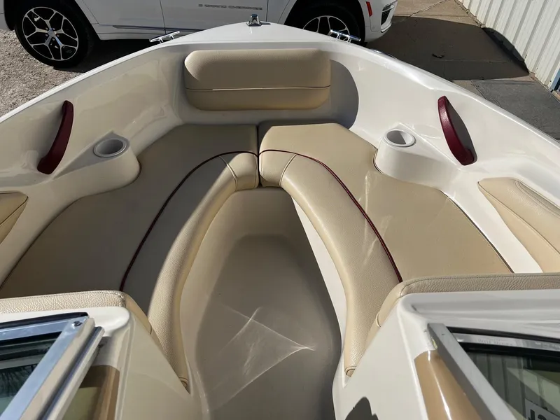 Slide: The Image of Interior of a 2000 Sea Ray 185 Bow Rider boat with beige seating and cup holders. - 5