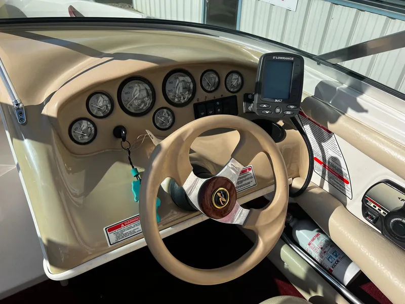 Slide: The Image of Dashboard of a 2000 Sea Ray 185 Bow Rider boat with steering wheel and gauges. - 7