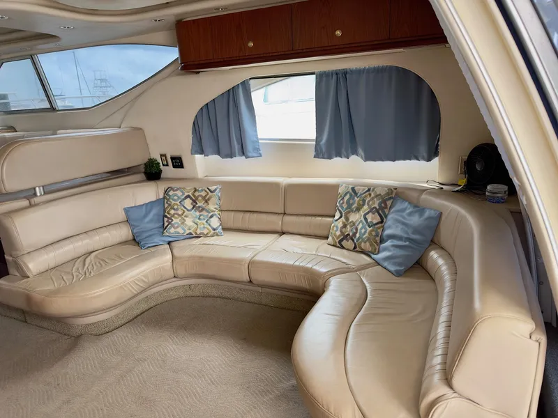 Slide: The Image of Luxurious interior of 1998 Maxum 4600 SCB yacht with curved leather seating and decorative pillows. - 15