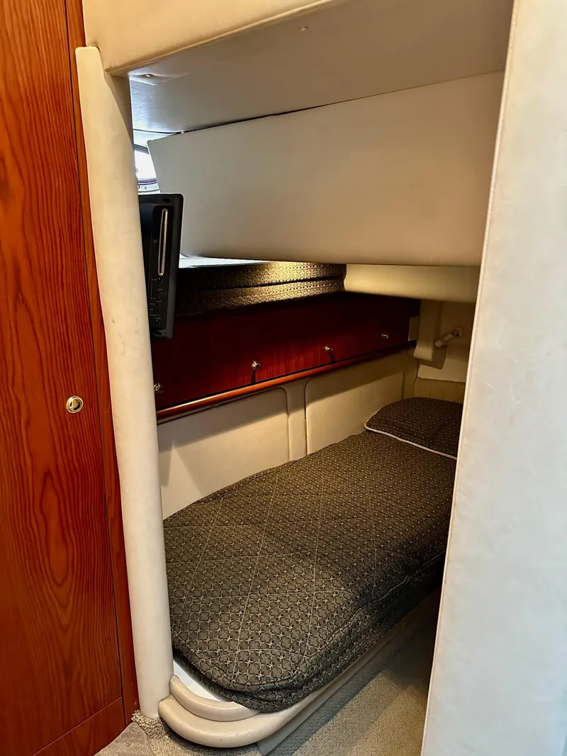 Slide: The Image of Cozy cabin interior of 1998 Maxum 4600 SCB yacht with single bed and wooden accents. - 20