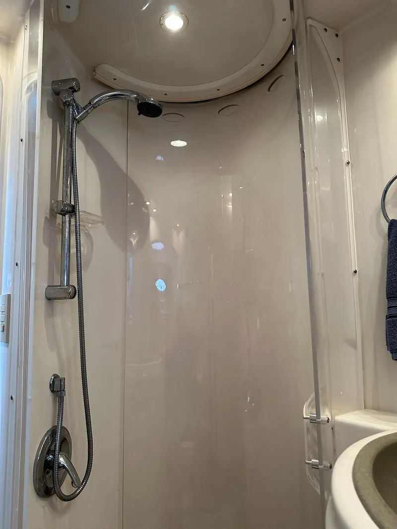 Slide: The Image of Shower area in a 1998 Maxum 4600 SCB yacht, featuring modern fixtures and lighting. - 22