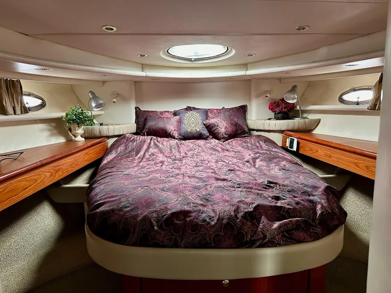 Slide: The Image of Luxurious bedroom interior of 1998 Maxum 4600 SCB yacht with elegant bedding and wood accents. - 24