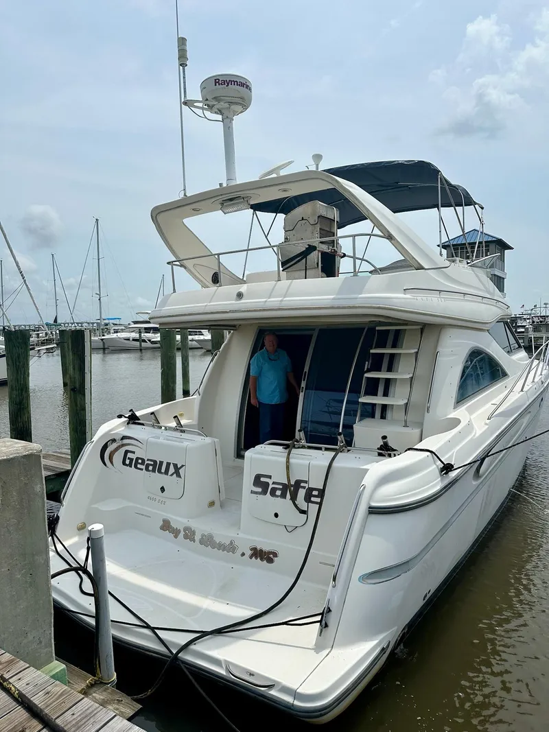 Slide: The Image of 1998 Maxum 4600 SCB yacht docked at marina, featuring sleek design and spacious deck. - 3