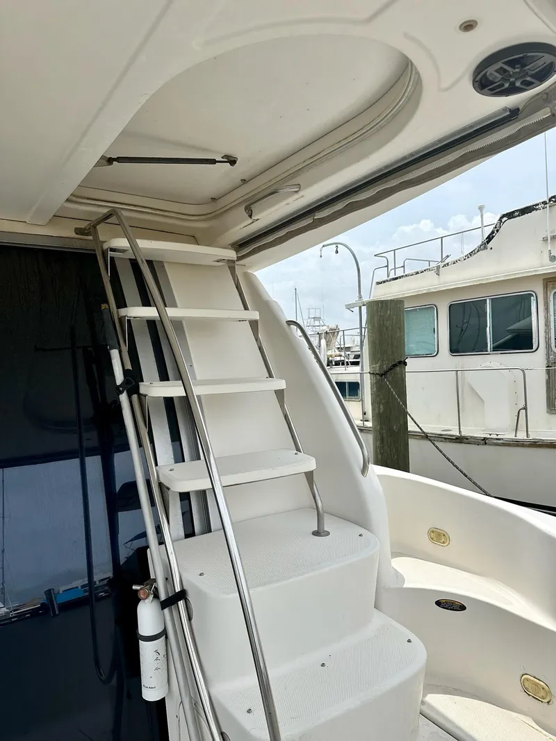 Slide: The Image of Staircase on 1998 Maxum 4600 SCB yacht, leading to upper deck, docked at marina. - 6