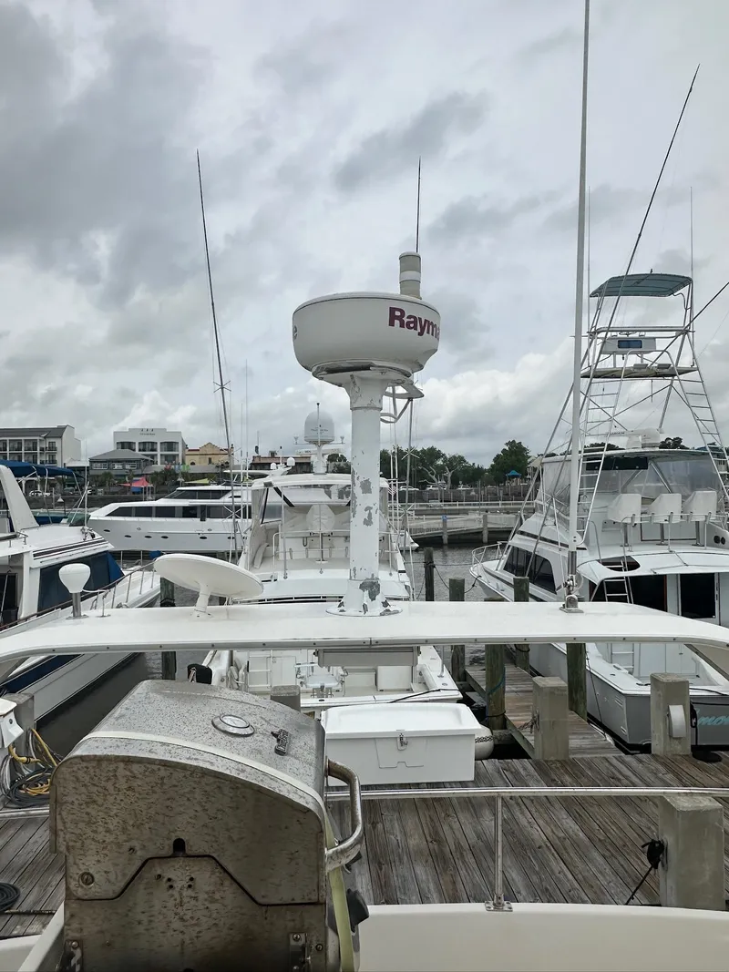 Slide: The Image of 1998 Maxum 4600 SCB yacht docked at marina under cloudy skies. - 9