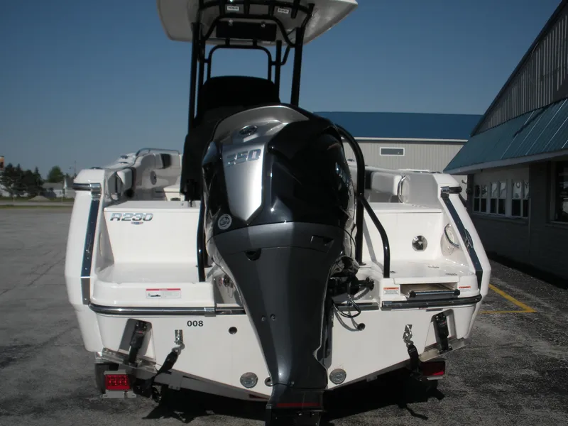 Slide: The Image of 2022 Robalo R230 Center Console boat rear view with outboard motor. - 3