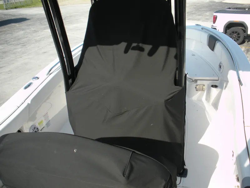 Slide: The Image of 2022 Robalo R230 Center Console boat interior with black seat covers. - 4