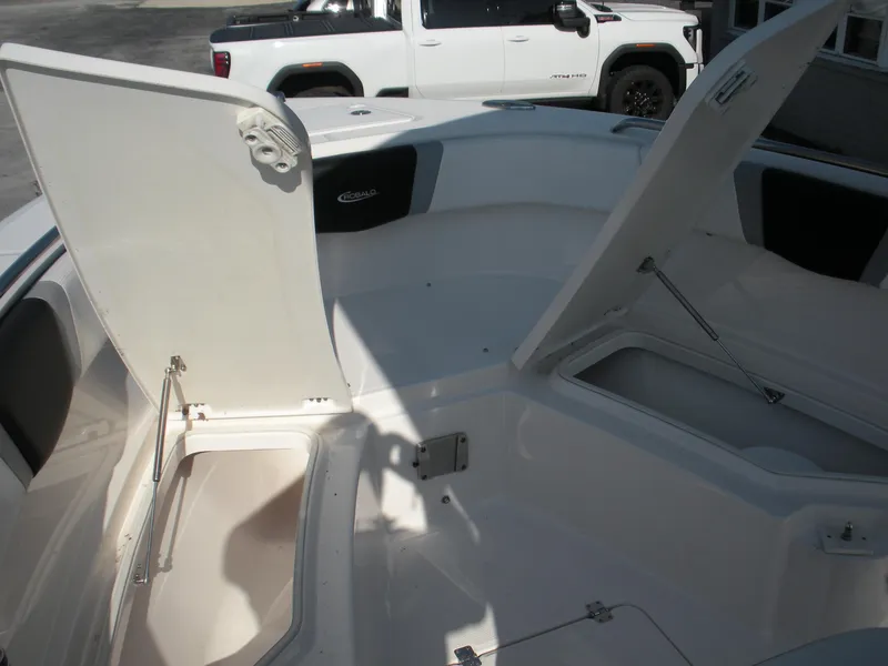 Slide: The Image of 2022 Robalo R230 Center Console boat with open storage compartments. - 6