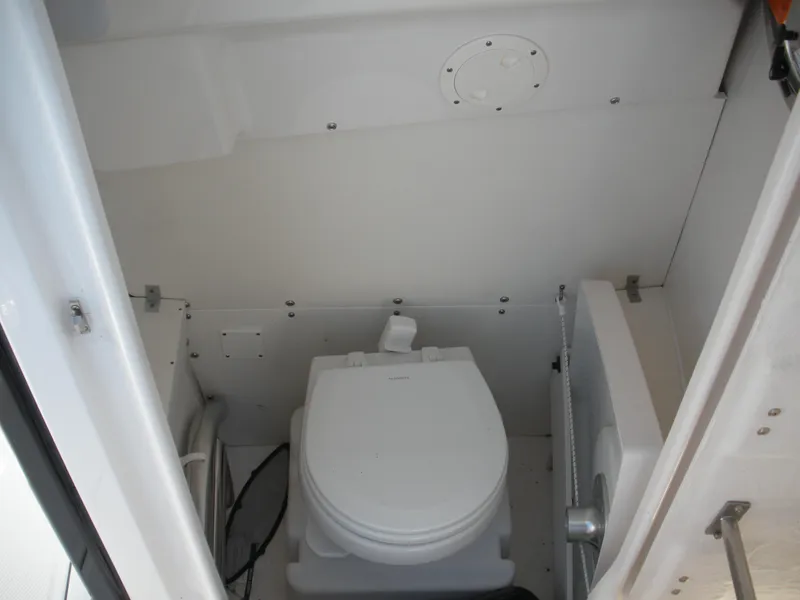 Slide: The Image of 2022 Robalo R230 Center Console boat interior toilet. - 8