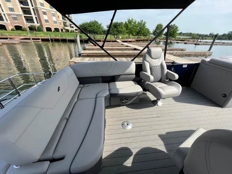 Slide: The Image of 2024 Starcraft SLS 3 Q DH pontoon boat interior with grey seating and waterfront view. - 5