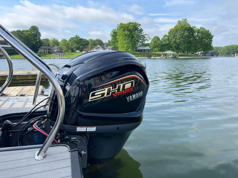 Slide: The Image of 2024 Starcraft SLS 3 Q DH boat with Yamaha SHO VMAX engine on a serene lake. - 8