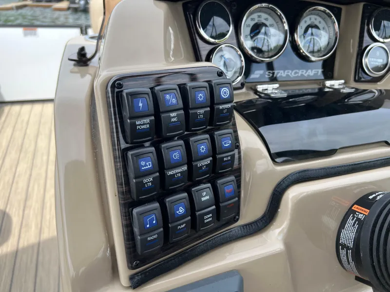 Slide: The Image of Control panel of a 2024 Starcraft SLS 3 boat with various switches and gauges. - 4