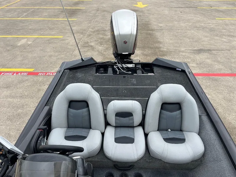Slide: The Image of 2018 Tracker Pro Team 190 boat with three gray seats and an outboard motor. - 27