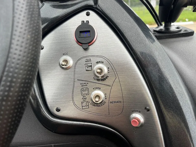 Slide: The Image of Control panel of a 2018 Tracker Pro Team 190 boat with various switches and a USB port. - 35