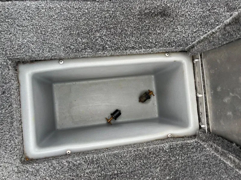 Slide: The Image of Storage compartment of 2018 Tracker Pro Team 190 boat with two small objects inside. - 39