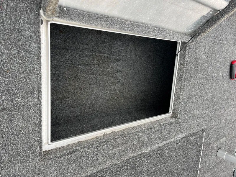 Slide: The Image of Open storage compartment on a 2018 Tracker Pro Team 190 boat. - 42