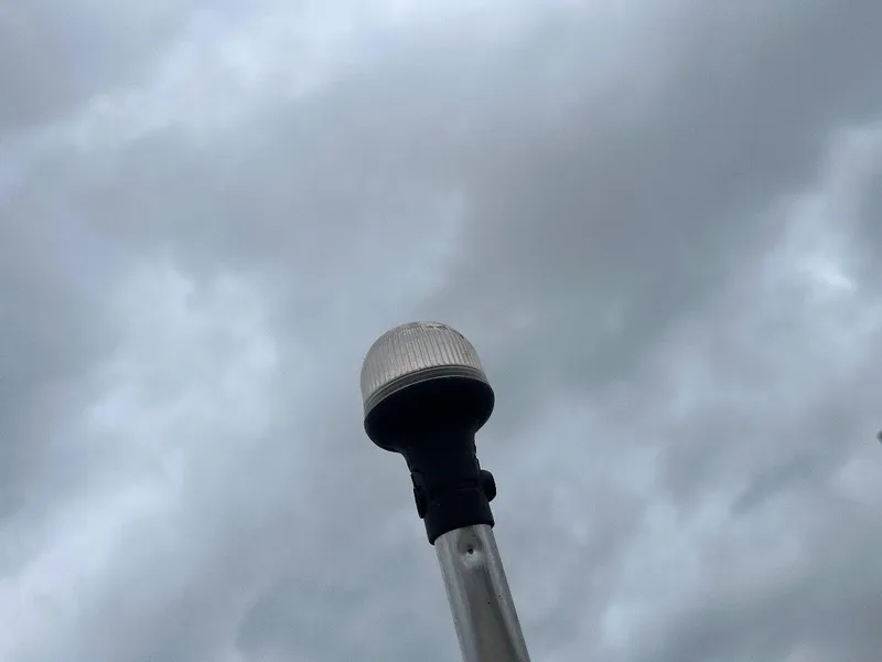 Slide: The Image of Navigation light on a 2018 Tracker Pro Team 190 boat against cloudy sky. - 50