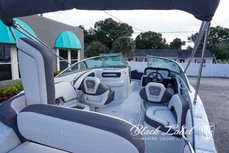 Slide: The Image of 2024 Crownline E240 XS boat interior with seating and steering wheel. - 13