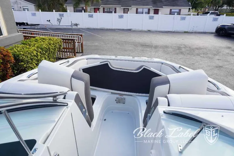Slide: The Image of 2024 Crownline E240 XS boat interior with seating, Black Label Marine Group logo. - 16