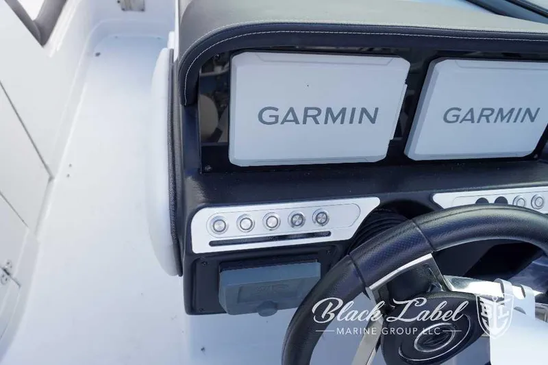 Slide: The Image of 2024 Crownline E240 XS boat dashboard with Garmin displays and Black Label Marine Group logo. - 22