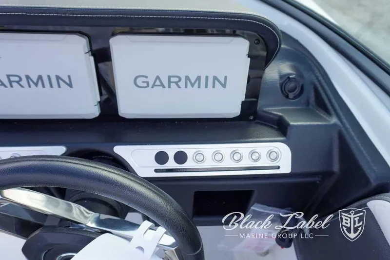 Slide: The Image of 2024 Crownline E240 XS boat dashboard with Garmin navigation system. - 23