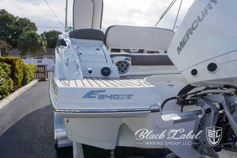 Slide: The Image of 2024 Crownline E240 XS boat rear view with Mercury engine, showcased by Black Label Marine Group. - 4