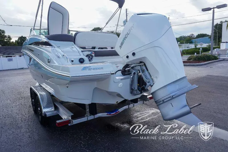 Slide: The Image of 2024 Crownline E240 XS boat on trailer with Mercury outboard engine. - 6