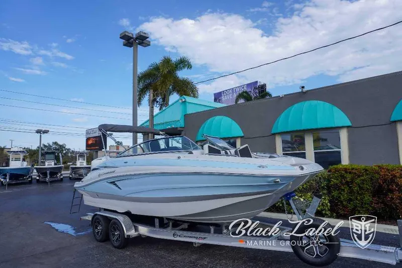 Slide: The Image of 2024 Crownline E240 XS boat on trailer at Black Label Marine Group dealership. - 9