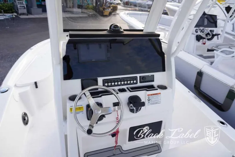 Slide: The Image of 2024 Sea Fox 251 Bay boat dashboard with steering wheel and control panel. - 10