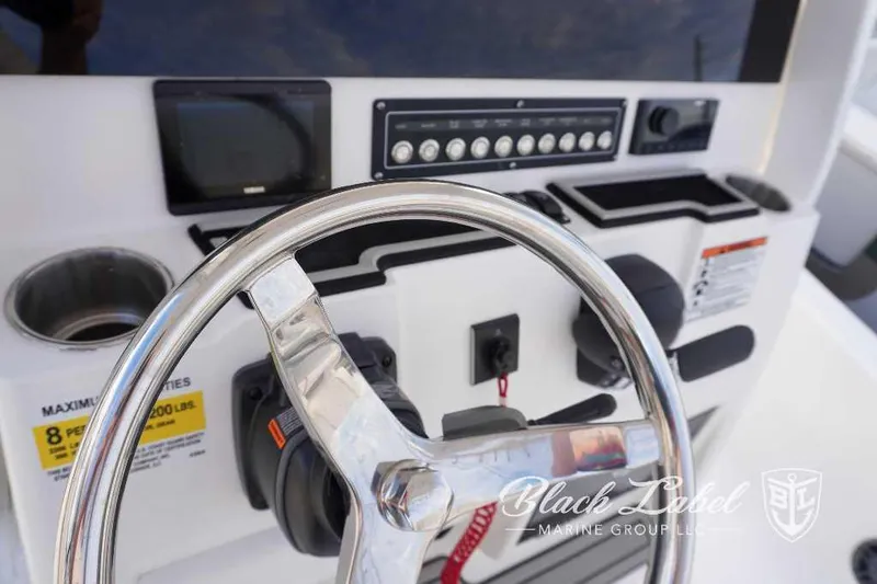 Slide: The Image of 2024 Sea Fox 251 Bay boat helm with steering wheel and control panel. - 19