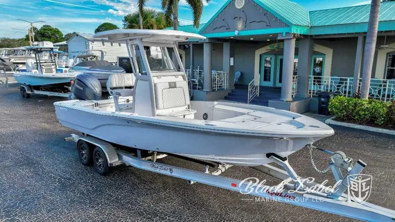 The Image of 2024 Sea Fox Seafox 251 Bay boat on a trailer outside a marine dealership. - 0