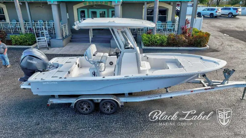Slide: The Image of 2024 Sea Fox Seafox 251 Bay boat on trailer, displayed by Black Label Marine Group. - 1