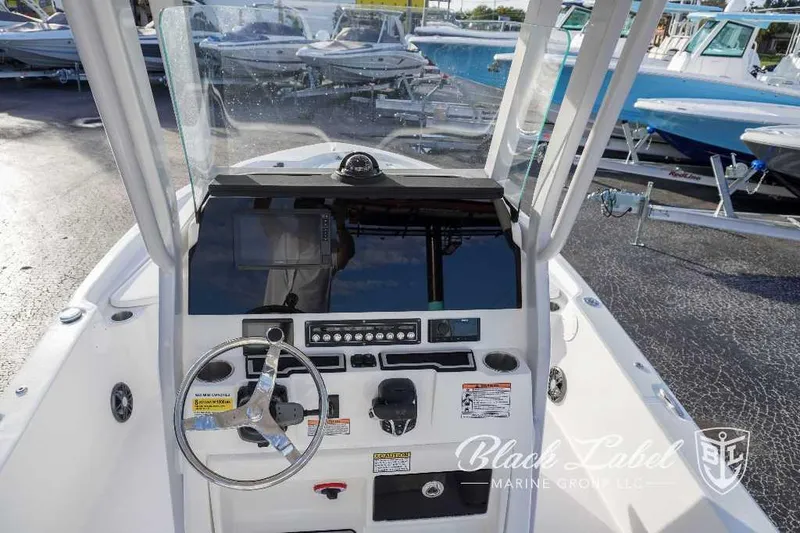 Slide: The Image of 2024 Sea Fox Seafox 251 Bay boat console with steering wheel and controls. - 19
