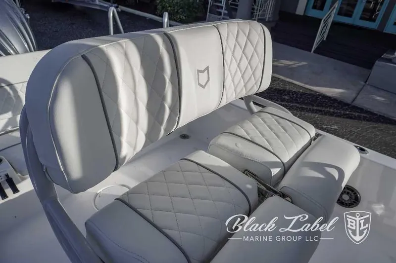 Slide: The Image of 2024 Sea Fox Seafox 251 Bay boat seating with diamond-stitched upholstery, Black Label Marine Group logo. - 21