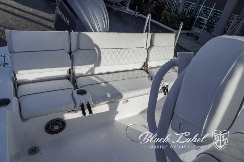 Slide: The Image of 2024 Sea Fox Seafox 251 Bay boat interior seating with cup holders and Yamaha engine. - 22